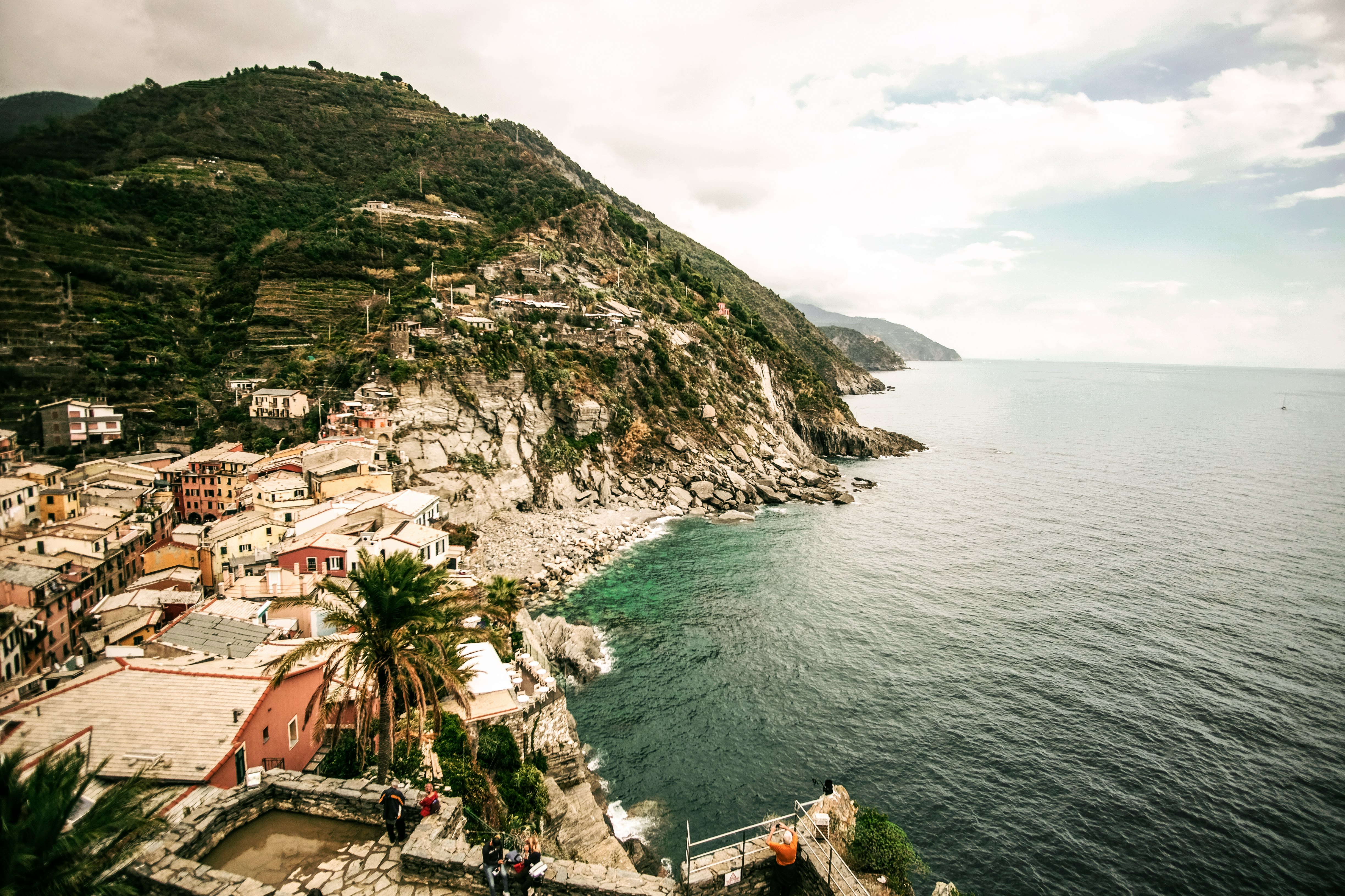 town beside body of water and hill during daytime